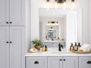 Custom gray bathroom vanity and storage cabinetry in Tampa Bay remodel