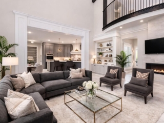 Full-home remodeling project in Tampa Bay featuring open living room, fireplace wall, integrated kitchen, and loft-style upper level
