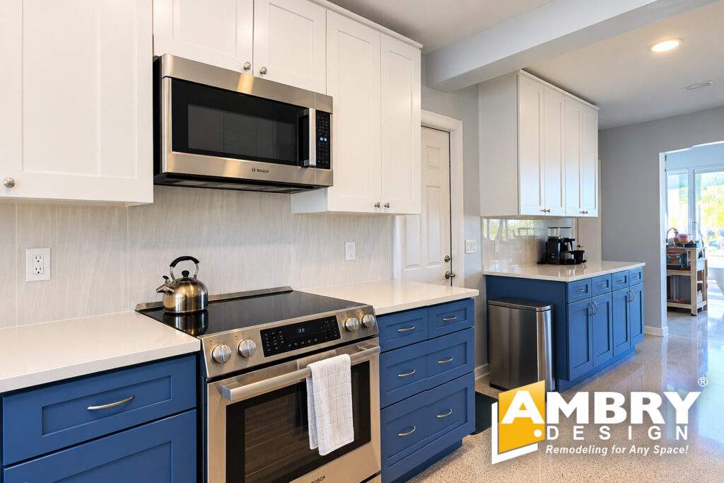 Kitchen remodel by Ambry Design with blue base cabinets and quartz counters